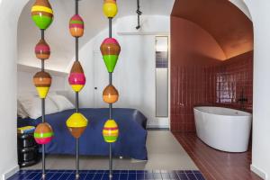 a bathroom with colorful lights on the wall at BLU - Apulian Suite in Bari +12 photos