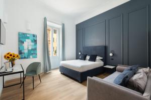 a bedroom with a bed and a living room with a couch at DA ME Suites in Rome