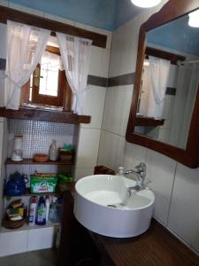 a bathroom with a sink and a mirror at Kiwi stonehouse in Chorefto +44 photos
