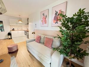 a living room with a white couch and a plant at 123home- Garden & Spa in Serris