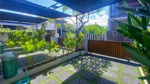 a garden with many plants in a building at Andewi Homestay RedPartner - Minimum Stay 30 Nights in Pesanggaran