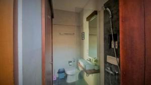 a small bathroom with a toilet and a sink at Andewi Homestay RedPartner - Minimum Stay 30 Nights in Pesanggaran
