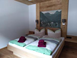 a bed with two pillows on it in a room at Alpenchalet Breitspitz in Partenen