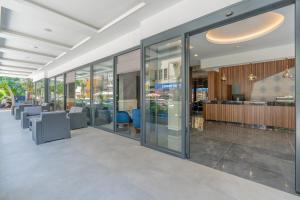 an office building with glass windows and a lobby at Gurses Life Hotel in Alanya