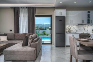 a living room with a couch and a table and a kitchen at Blue Wind Villa II in Sarakinádhon