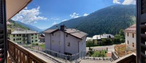 a view from a balcony of a town with mountains at Appartamento Silvia in Vermiglio