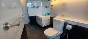 a bathroom with a white toilet and a sink at SY Staycation - Apartment in Bayan Lepas +13 photos