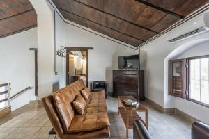 a living room with a couch and a table at Casa Rural San Miguel in Morón de la Frontera