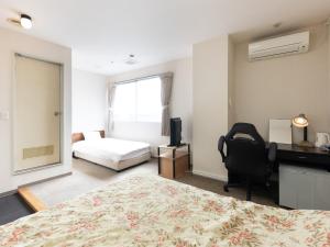Postel nebo postele na pokoji v ubytování Tabist Tatebayashi Station Hotel