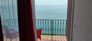 a room with a view of the ocean from a balcony at Villa Eros Apartments 2 in Struga