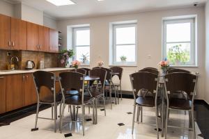 a kitchen with a table and chairs in a room at Western Hills in Gdańsk