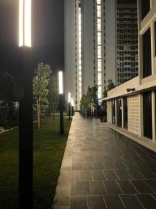 a walkway in a city at night with street lights at Horizon Suite Homestay, KLIA by S&T Homez in Sepang