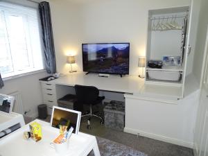 a white desk with a computer on top of it at Stony Apartment House in Doncaster +35 photos