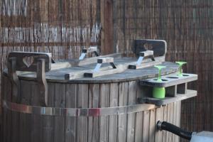 a wooden bath tub with four chairs in it at Angela's Rest Shepherds Hut with Scandi Hot Tub in Boston