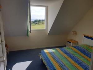 1 dormitorio con cama y ventana en Location LOC'MARIA - Résidence Marie-Galante - Location Professionnelle en Locmaria