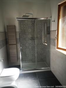 a glass shower in a bathroom with a toilet at Casa vacanze low cost in Gallipoli