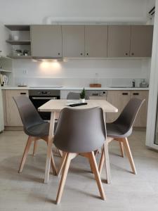 a kitchen with a table and four chairs at Sti Chora Apartments in Lefkada Town