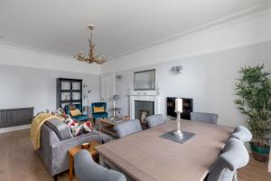 a living room with a table and a couch at Glamorous flat near City Centre in Edinburgh