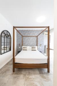 a bed with a wooden frame in a room at Hotel Brennero in Verona