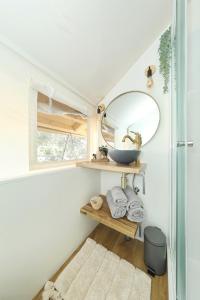 a bathroom with a sink and a mirror at AURAS - Glamping Eco Resort in Biograd na Moru