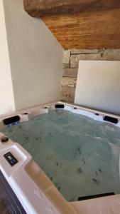 a jacuzzi tub in a room with at Casinhas da eira caramulo turismo rural in Arca