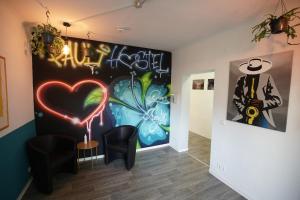 a room with a wall with graffiti on it at Pauli Hostel in Hamburg