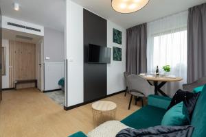 a living room with a couch and a table at Baltic Apartment Marynarska by Noclegi Renters in Sarbinowo