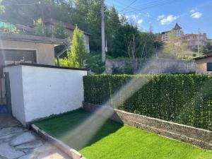 a garden with a sprinkler watering the grass at Апартамент Фреш in Velingrad