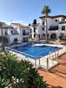 a large swimming pool in front of some buildings at NUEVA NERJA Pueblo Andaluz Casa Grafton in Nerja