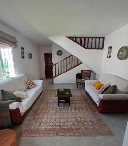 a living room with two couches and a coffee table at NUEVA NERJA Pueblo Andaluz Casa Grafton in Nerja