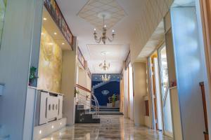 a hallway in a building with a chandelier at Hotel Turist in Pucioasa