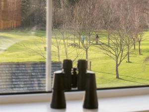 a view of a golf course from a window at LakeSide House in Keswick