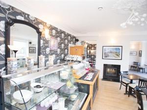 a room with a counter and a fireplace in a store at LakeSide House in Keswick