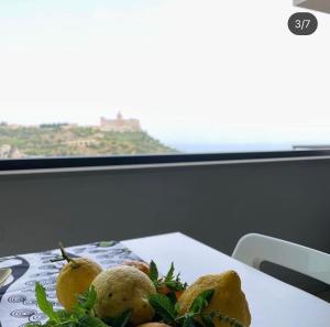 a plate of food on a table with a view at La Casa del Riccio in Tindari