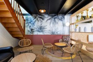 a room with tables and chairs and a mural at Greet Hôtel Villeneuve la Garenne - rénové in Villeneuve-la-Garenne +36 photos