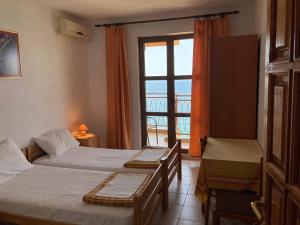 a hotel room with two beds and a window at Monterama Apartments in Sutomore