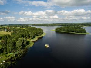 an aerial view of a boat on a lake at AQUA Bērzgale in Bērzgale