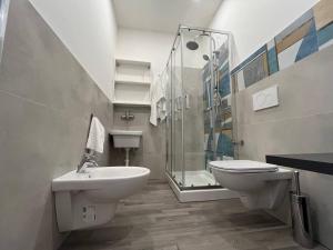 a bathroom with a toilet and a sink and a shower at Casa Vacanze Caramagna 2 in Aci Castello