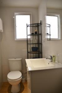 a bathroom with a toilet and a sink and a window at Old town - Beach apartment in Benidorm