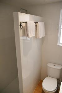 a bathroom with a white toilet and towels at Old town - Beach apartment in Benidorm