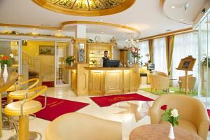 a man standing at a bar in a restaurant at Park Hotel Laim Serviced Apartments in Munich