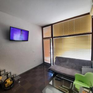 a hospital room with a chair and a flat screen tv at Apartment Kristjan in Portorož