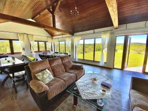 a living room with a couch and a table at Pensiunea Ivoire in Avrig