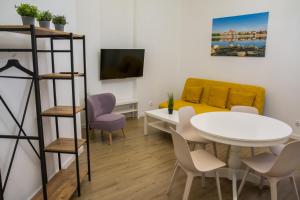 a living room with a table and chairs and a bed at P&M Apartament in Toruń