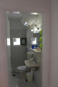 a bathroom with a toilet and a sink at Dioni Lux inn 2 in Pachaina +22 photos