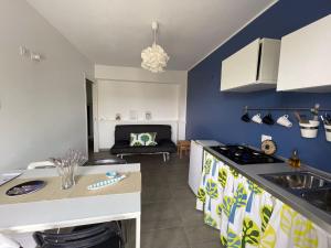 a kitchen and living room with a stove top oven at La Casa del Riccio in Tindari