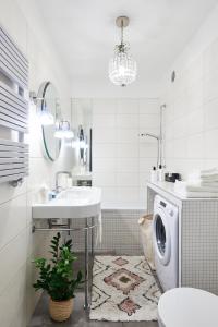 a bathroom with a sink and a washing machine at Loved Up Sea Home in Sopot