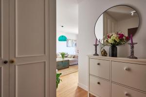 a hallway with a dresser and a mirror at Loved Up Sea Home in Sopot