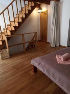 a bedroom with a staircase and a bed in a room at Casa Mali in Cres