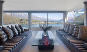 a living room with couches and a table with a view at Star Lane by Amazing Accom in Queenstown +8 photos